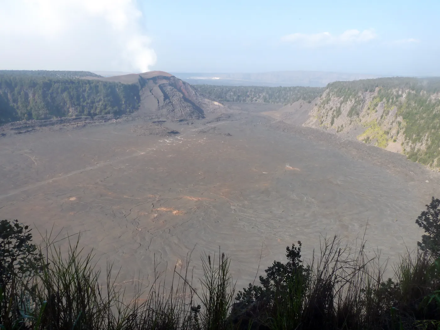 Hikers crossing the solidified lava floor of Kīlauea Iki crater